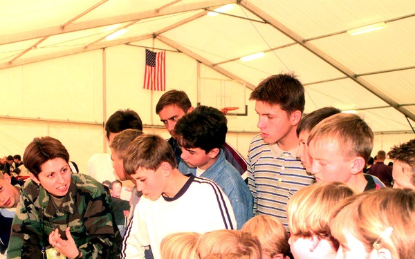 Children from Bosnia and Herzegovina listen to a translator explain the hazards of anti-personnel mines during Kids' Day.