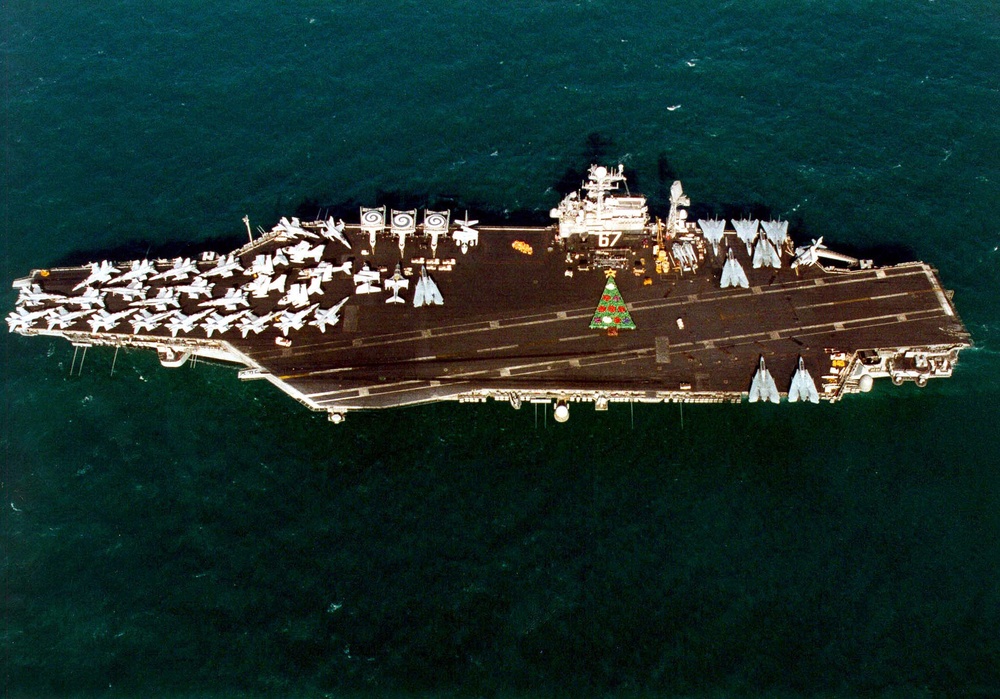 Over 1,000 sailors form a Christmas tree on the flight deck of the aircraft carrier USS John F. Kennedy.
