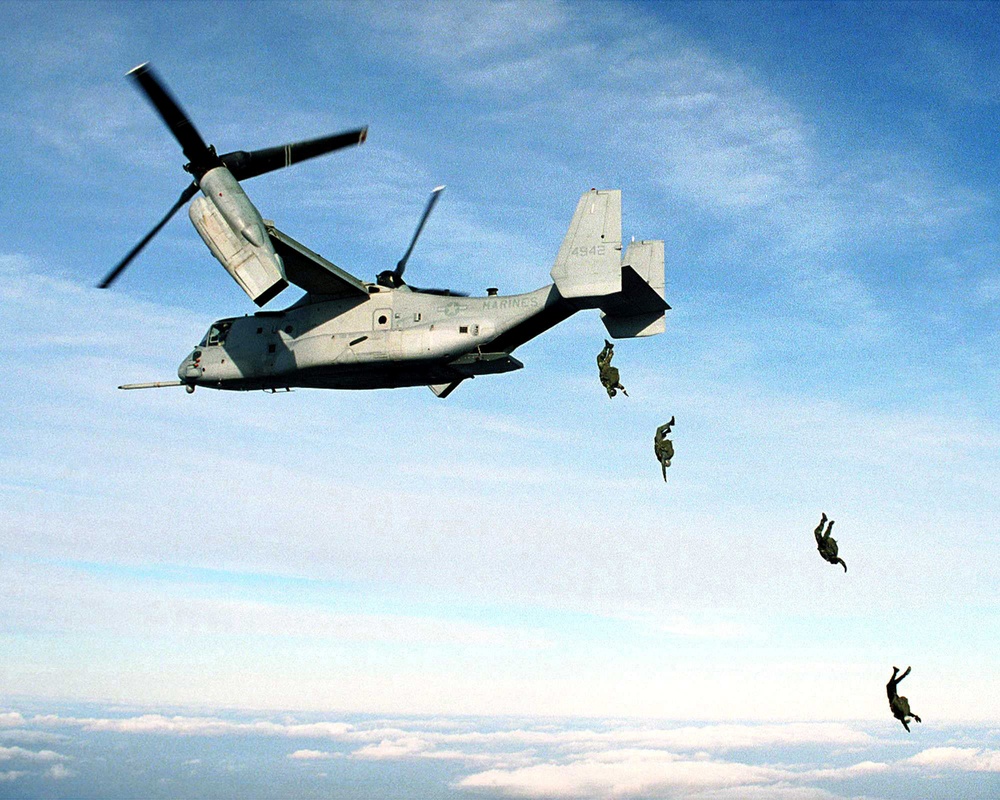 U.S. Marine Corps parachutists free fall from an MV-22 Osprey at 10,000 feet.
