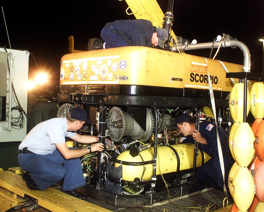 Sailors perform routine checks of the remotely piloted vehicle SCORPIO on the deck of the MV Kellie Chouest.