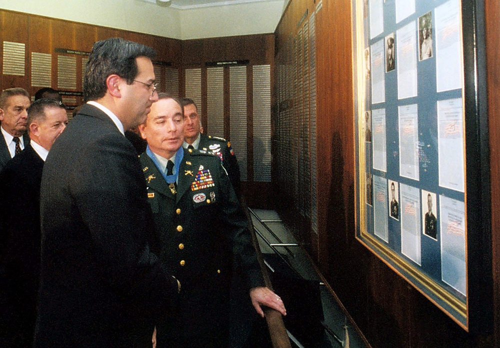 Secretary of the Army Caldera and Alfred Rascon look at a photograph of Rascon and the citation for his Medal of Honor in the Pentagon.