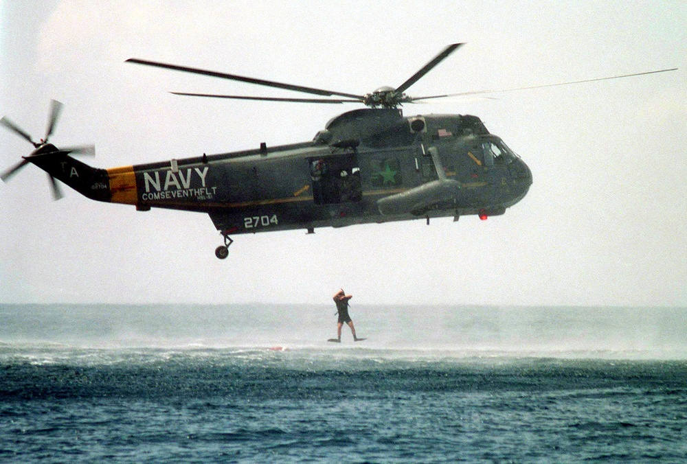 Navy rescue swimmer Mark Podzon jumps from a SH-3H Sea King helicopter into the Flores Sea in Indonesia.
