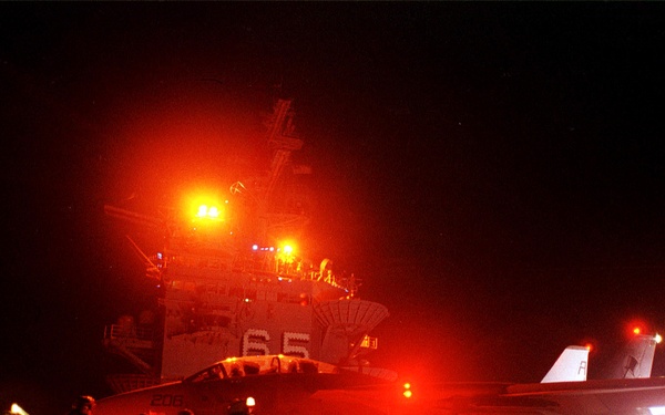 A U.S. Navy F-14A Tomcat goes into full afterburner as it prepares to catapult from the flight deck of USS Enterprise.