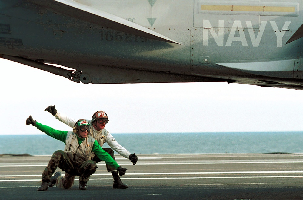 Two members of the Rampagers give the thumbs up for the launch of one of the squadron's F/A-18C Hornets.