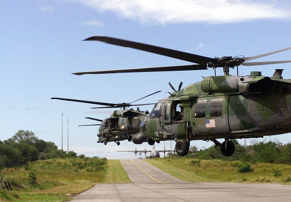 Three HH-60 Pave Hawk helicopters lift off from Hoedspruit Air Force Base, South Africa, during Operation Atlas Response.