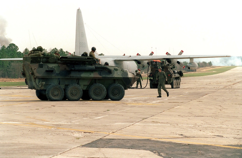 U.S. Marines from the Light Armored Reconnaissance Battalion refuel their light armored vehicles from a C-130 Hercules.