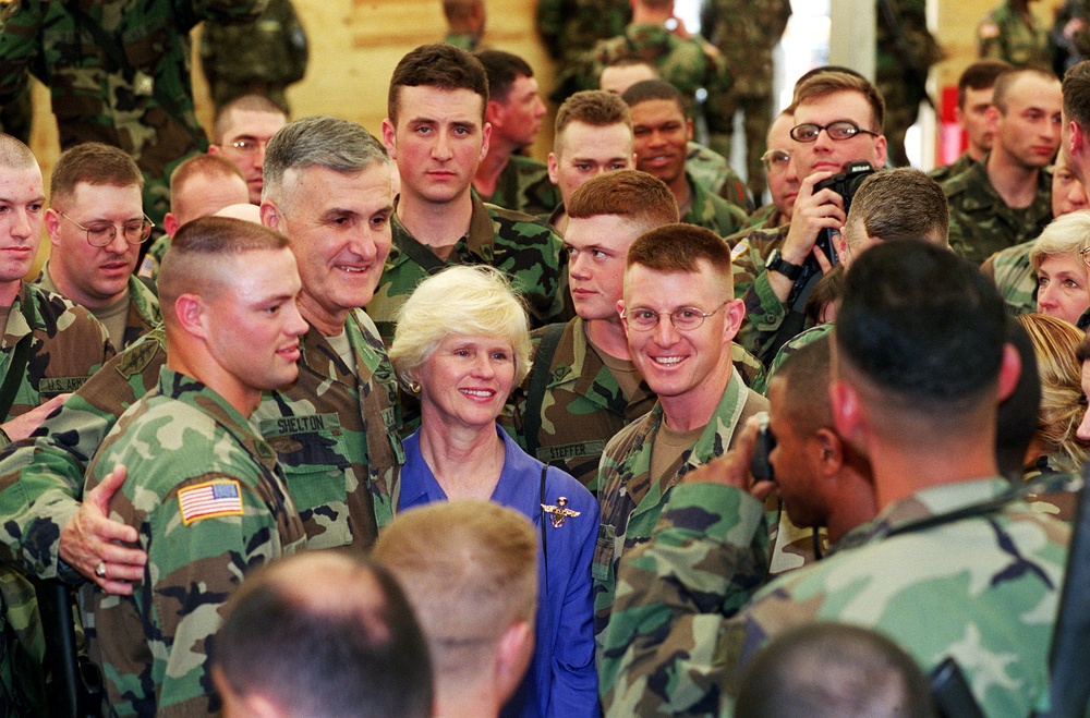 Gen. Shelton and his wife Carolyn pose for photographs with soldiers of Task Force Falcon.