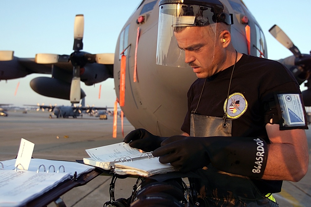 Staff Sgt. Stepp looks over the maintenance records of a C-130 prior to the Rodeo 2000 maintenance competition.