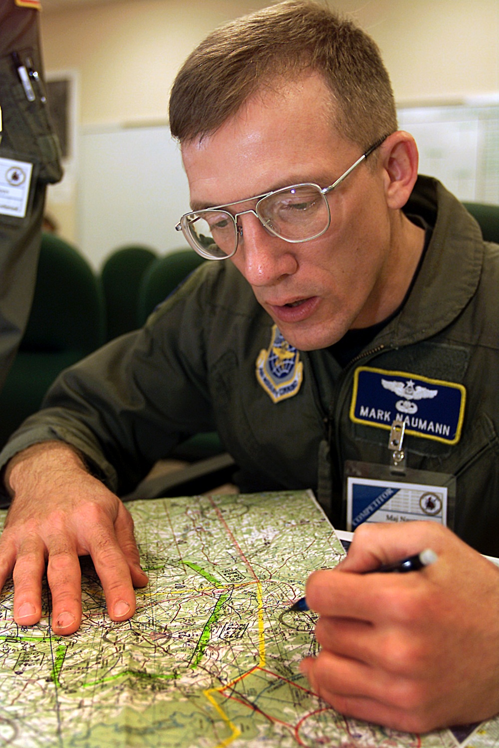 C-130 Hercules Navigator Maj. Naumann prepares his mission brief prior to takeoff on a mission from Pope for Rodeo 2000.