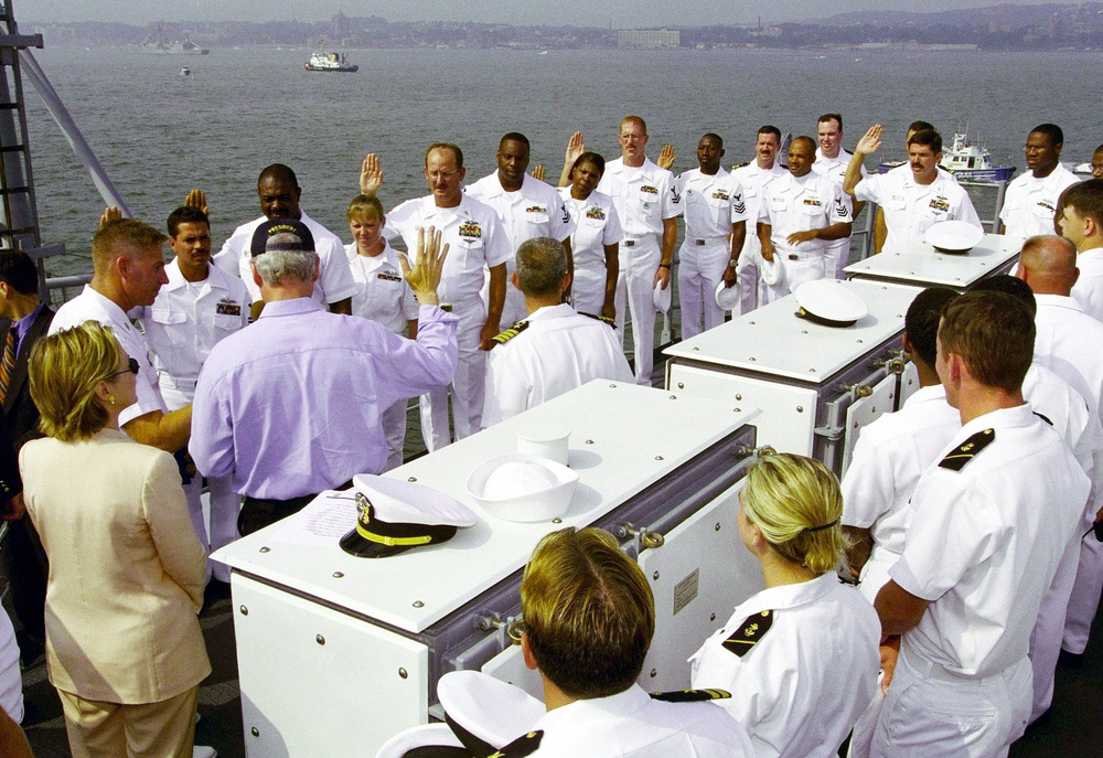 President Bill Clinton reads the oath of re-enlistment to a group of sailors aboard the USS Hue City (CG 66).