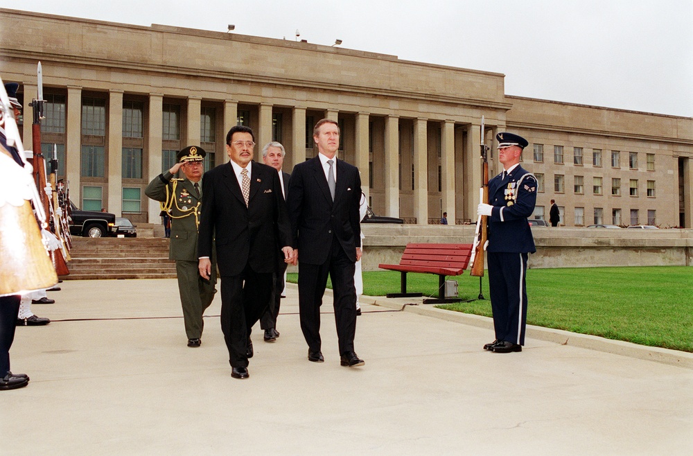 Secretary Cohen escorts Republic of the Philippines President Joseph Estrada to the Pentagon parade field for a welcoming ceremony.