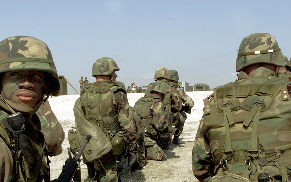 Sgt. Ronnie Guerra and other U.S. Marines prepare for a simulated attack on Vadu Beach, Romania, during Exercise Rescue Eagle 2000.