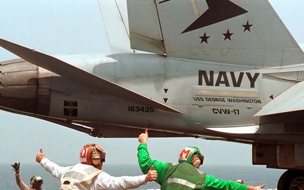Petty Officers Curphey and Eads signal a thumbs-up for the  launch of an F/A-18C Hornet from the USS George Washington.