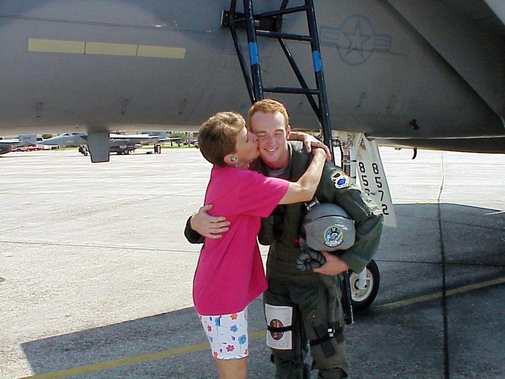 Lori Zimmerman kisses her son Dale Zimmerman after he completed his orientation flight in an F-15 Eagle.