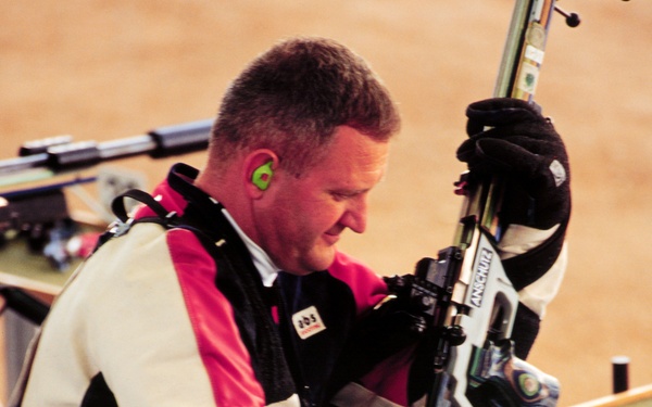 Capt. Glenn A. Dubis prepares to shoot from the kneeling position during qualifications for the Men's 50 meter rifle.