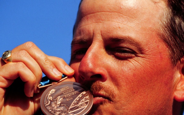 Sgt. 1st Class James T. Graves kisses the bronze medal he won in the Men's Skeet competition at the 2000 Olympic Games.