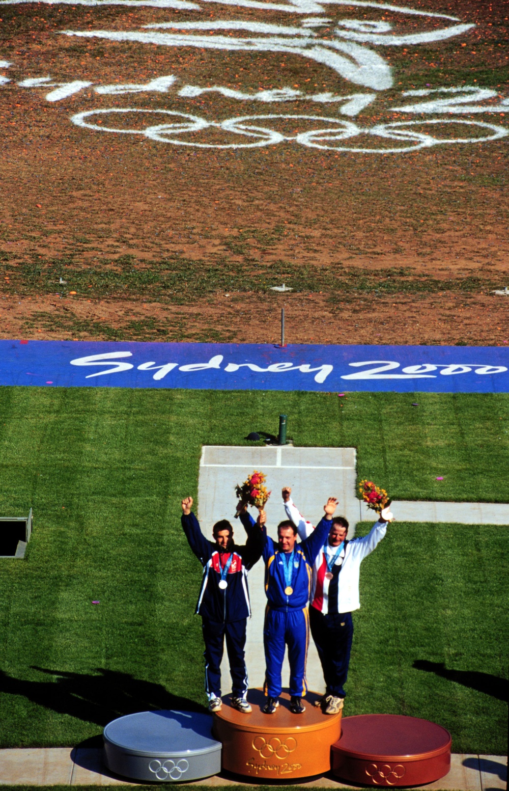 Sgt. 1st Class James T. Graves joins his competitors on the medals platform after winning the bronze medal.