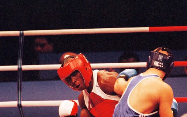 Staff Sgt. Olanda Anderson avoids a jab from his opponent Rudolf Kraj during the men's light heavyweight boxing match.