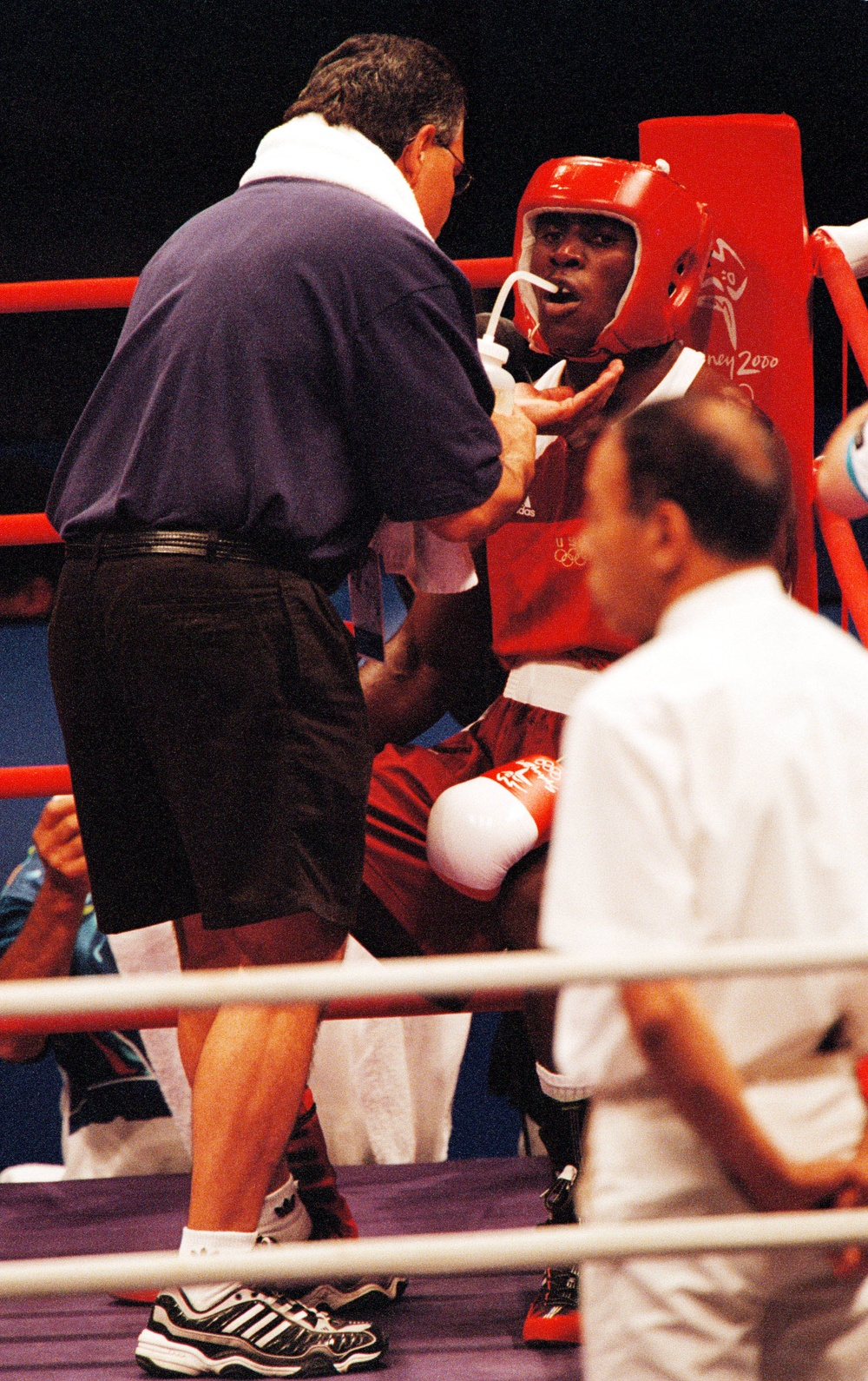 Staff Sgt. Olanda Anderson drinks some water as he sits in the red corner during his light heavyweight boxing match.
