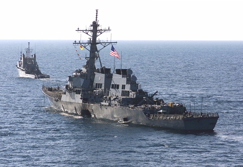 The USS Cole is towed away from the port city of Aden, Yemen, into open sea by the ocean-going tug USNS Catawba.