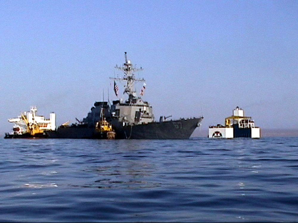 The USS Cole waits for the M/V Blue Marlin to maneuver under the destroyer off the coast of Aden, Yemen.