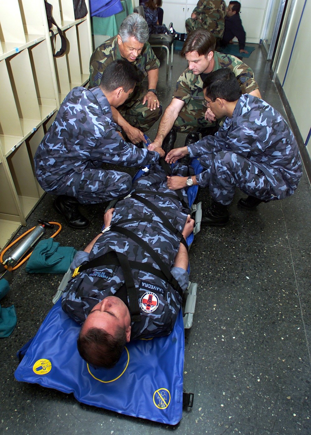 Chilean Air Force members show Chief Master Sgt. Tobo and Tech. Sgt. Scott Drake their application of an air-splint.