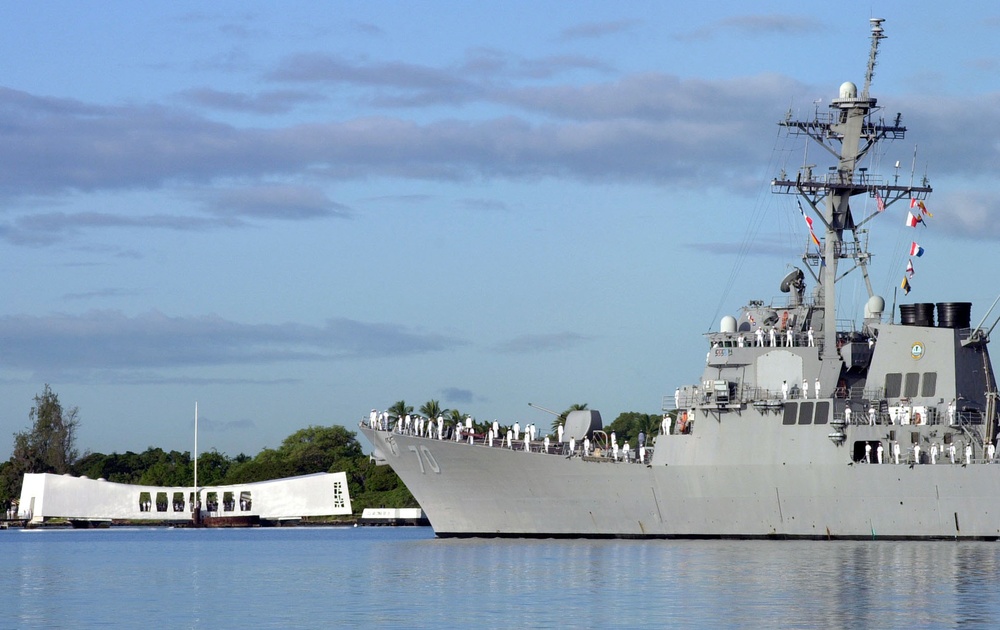 Sailors man the rail of the USS Hopper (DDG 70) as it parades by the USS Arizona Memorial on Dec. 7, 2000.