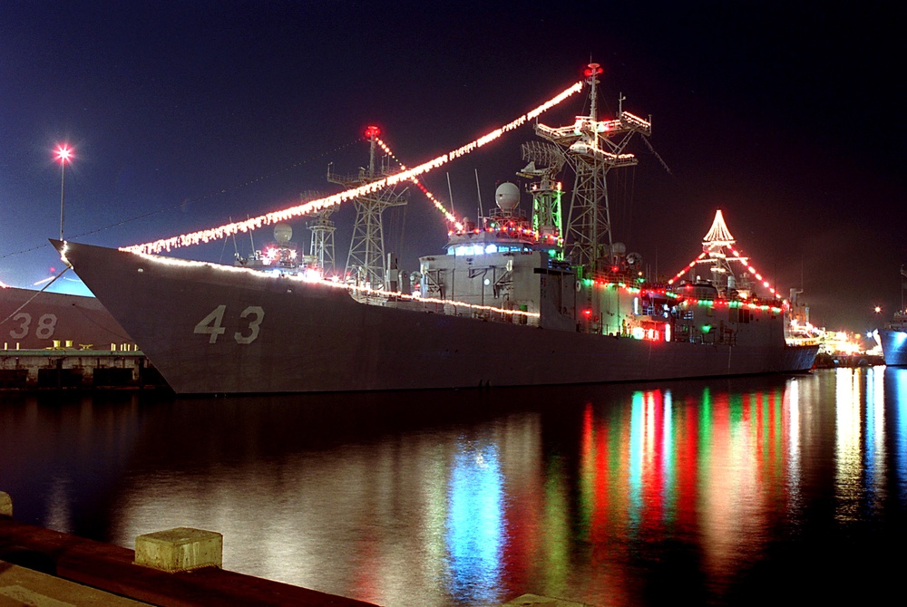 Red, green and white holiday lights outline the USS Thach (FFG 43) in San Diego.
