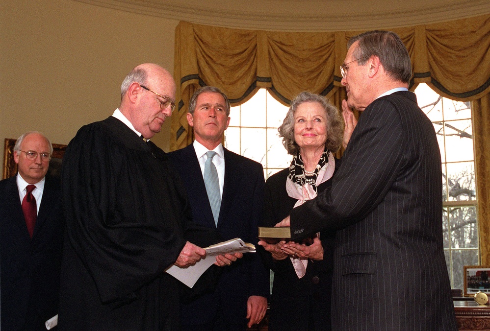 President Bush and Vice President Cheney watch as Donald H. Rumsfeld is administered the oath of office as the 21st secretary of Defense.