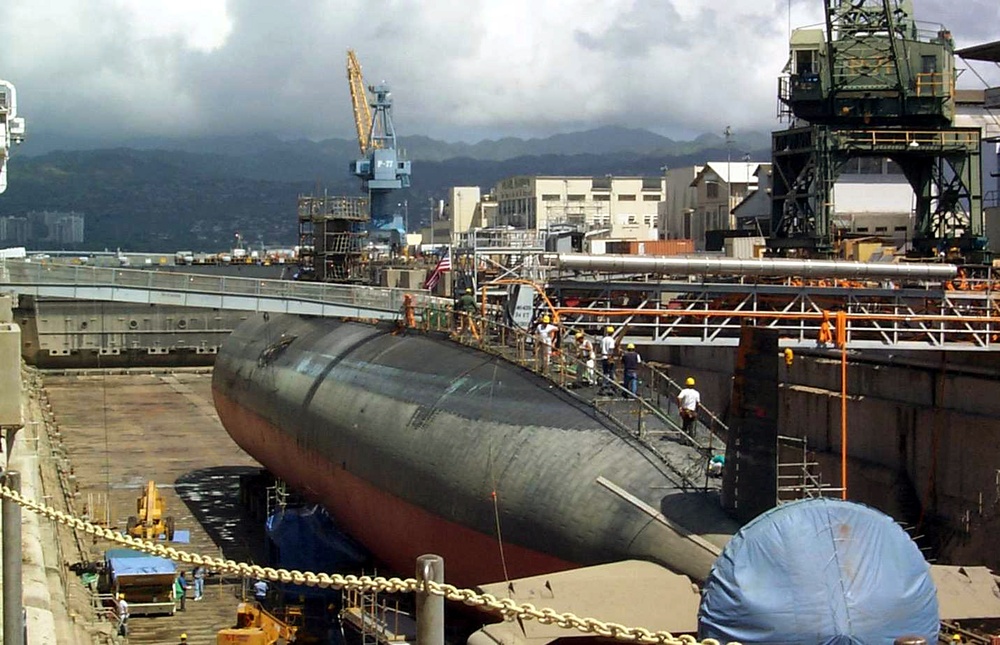 Shipyard workers examine the USS Greeneville (SSN 772) in Dry Dock #1 at Pearl Harbor.