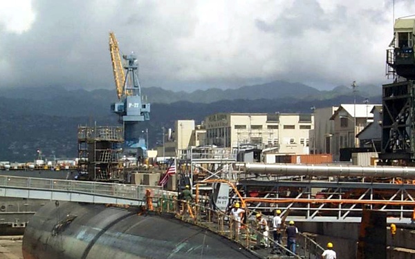 Shipyard workers examine the USS Greeneville (SSN 772) in Dry Dock #1 at Pearl Harbor.