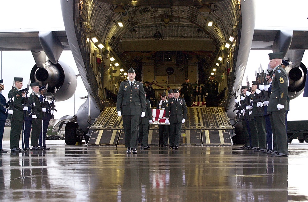 U.S. Army casket bearers carry the remains of one of six U.S. servicemen killed in a March 12 training exercise in Kuwait.