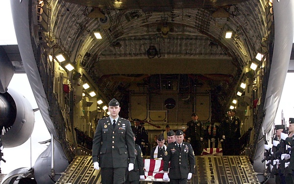 U.S. Army casket bearers carry the remains of one of six U.S. servicemen killed in a March 12 training exercise in Kuwait.
