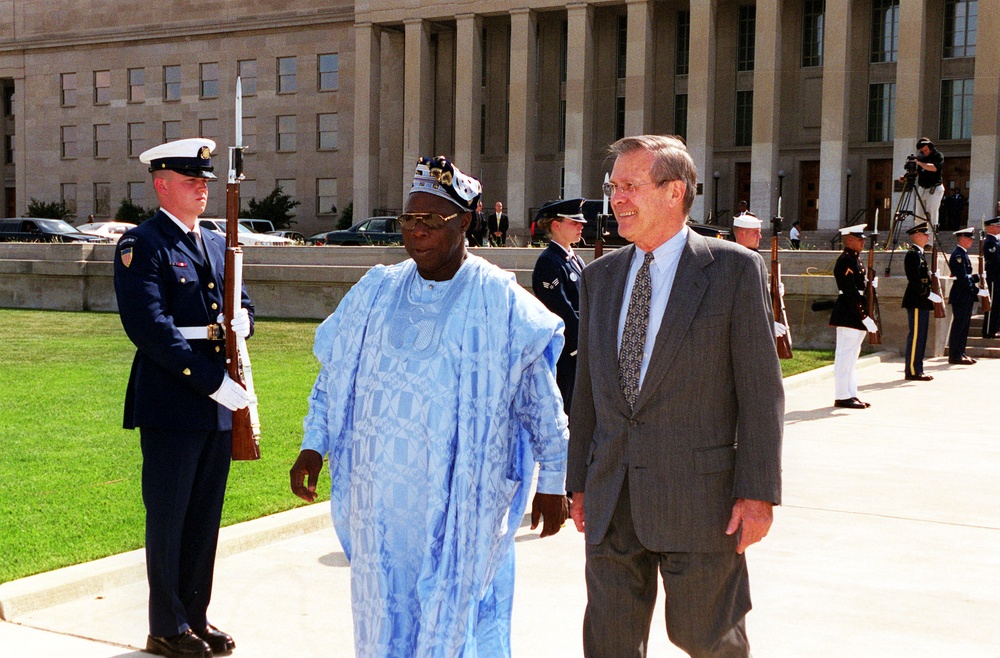 Secretary Rumsfeld escorts President Olusegun Obasanjo, of the Federal Republic of Nigeria, to the Pentagon parade field.