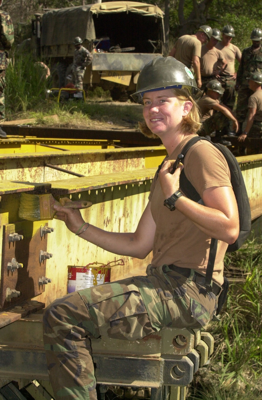 Builder Constructionman Ida Grigson paints bearers on a rebuilt bridge during Exercise Tandem Thrust 2001.