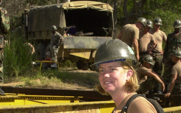 Builder Constructionman Ida Grigson paints bearers on a rebuilt bridge during Exercise Tandem Thrust 2001.