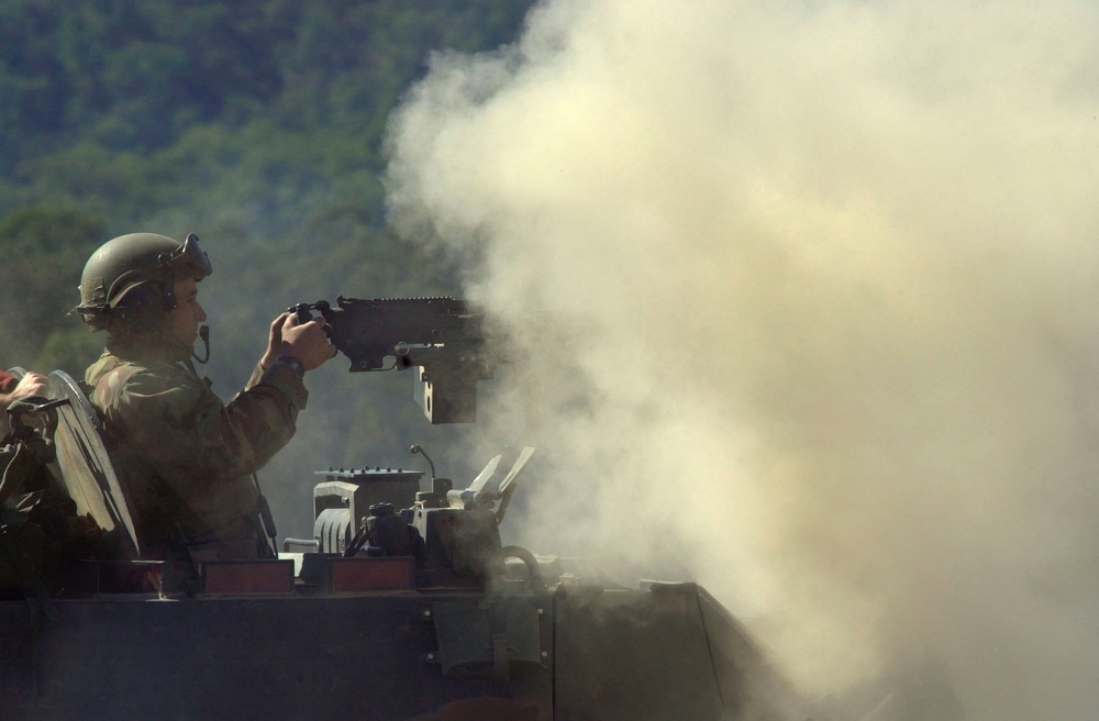 A Marine is almost engulfed with a cloud of smoke from his weapon during a live fire exercise at Shoalwater Bay Training Area.
