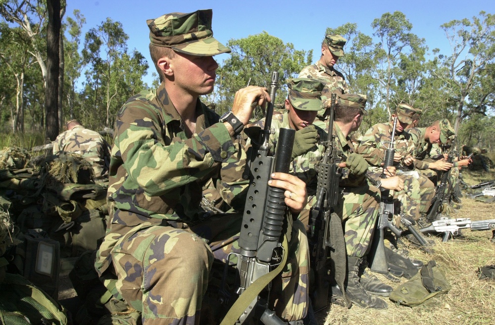 Cpl. Jason Brown cleans his M-203 40 mm grenade launcher before a battalion live fire exercise.
