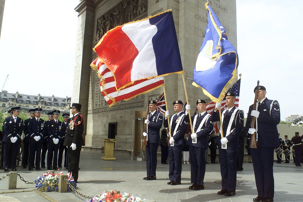 Members of the Special Security Squadron present the colors at the tomb of France's unknown soldier in the Arc de Triomphe.