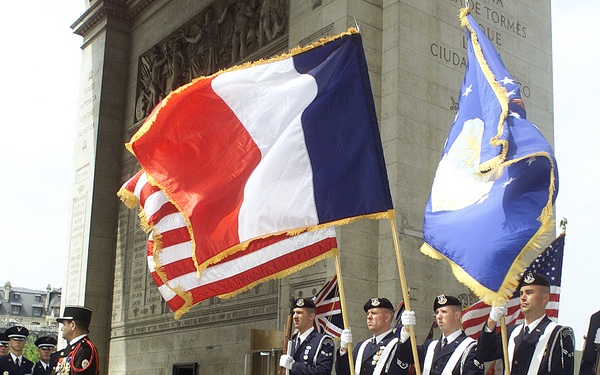 Members of the Special Security Squadron present the colors at the tomb of France's unknown soldier in the Arc de Triomphe.