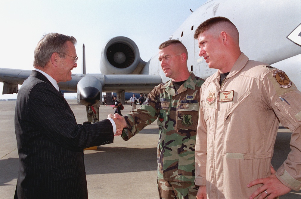 Secretary of Defense Rumsfeld greets Air Force Staff Sergeant Ward and Capt. Rasmussen (right) during his visit to Incirlik Air Base, Turkey.