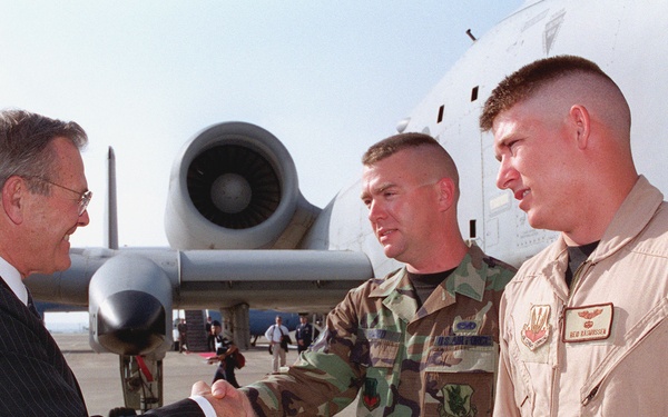 Secretary of Defense Rumsfeld greets Air Force Staff Sergeant Ward and Capt. Rasmussen (right) during his visit to Incirlik Air Base, Turkey.