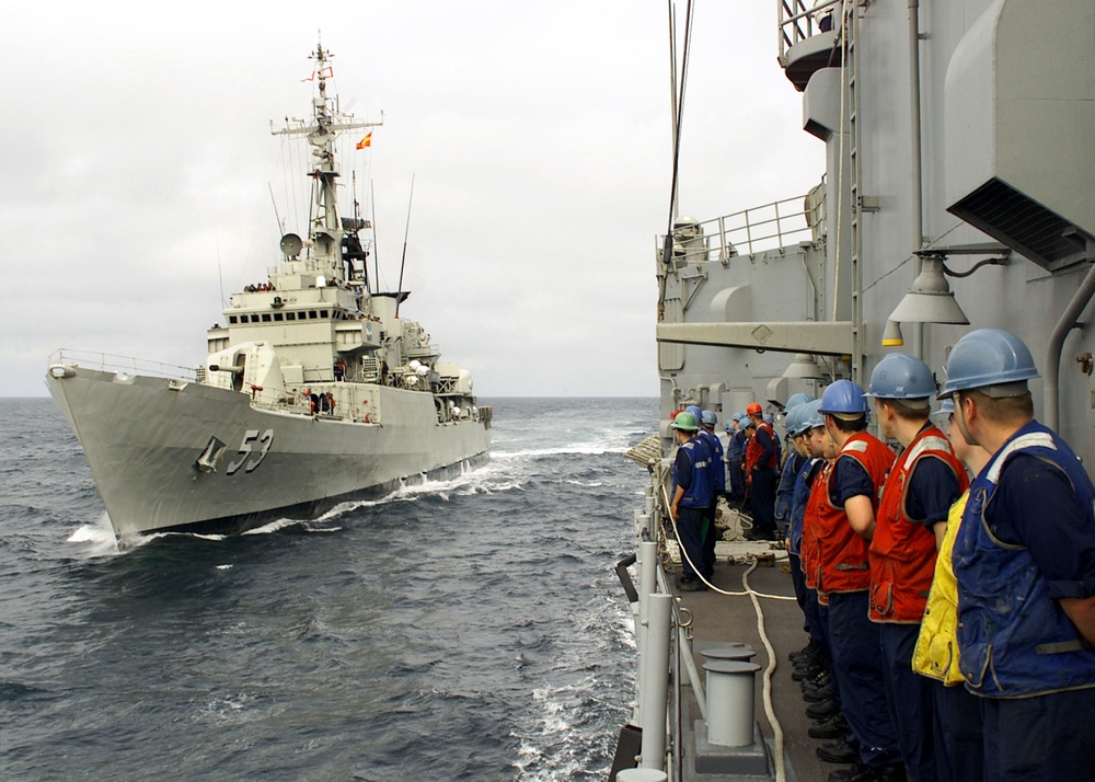 The crew of the USS Rodney M. Davis stands by as the Peruvian Frigate Montero comes alongside.