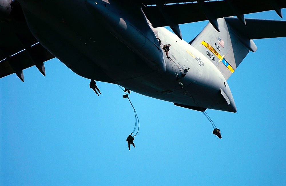 Soldiers of the Army's 82nd Airborne jump from an Air Force C-17 Globemaster III.