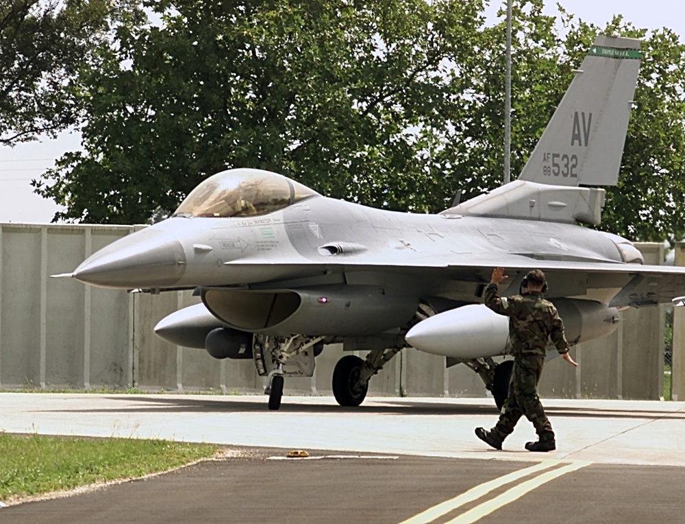 Airman 1st Class Dearl Stevens directs an F-16 Fighting Falcon after the aircraft landed at Aviano.