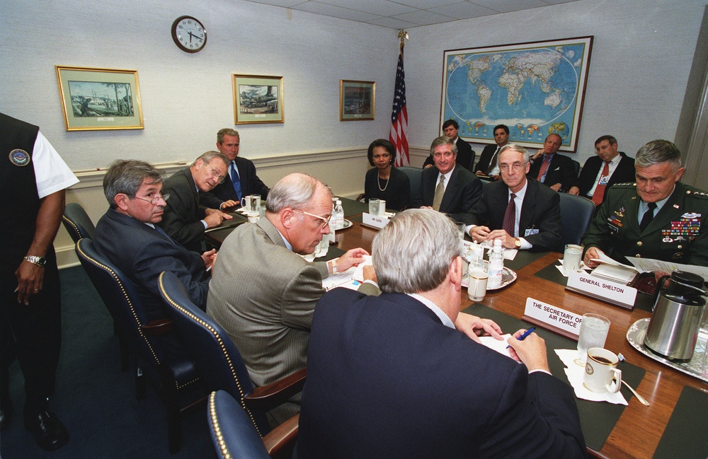 Secretary Rumsfeld introduces staff members to President Bush at their Pentagon meeting.