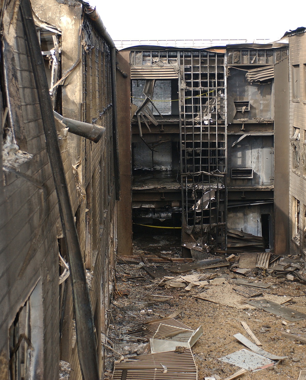 A wall of the E-Ring of the Pentagon leans inward and other walls show fire damage.
