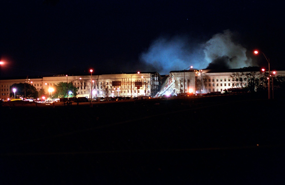 Fire fighters battle stubborn fires through the night at the Pentagon on Sept. 11, 2001.