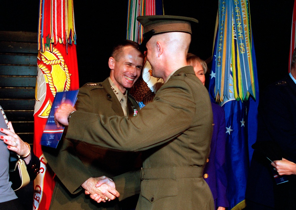 Marine Gen. Peter Pace, vice chairman of the Joint Chiefs of Staff, is congratulated by his son.