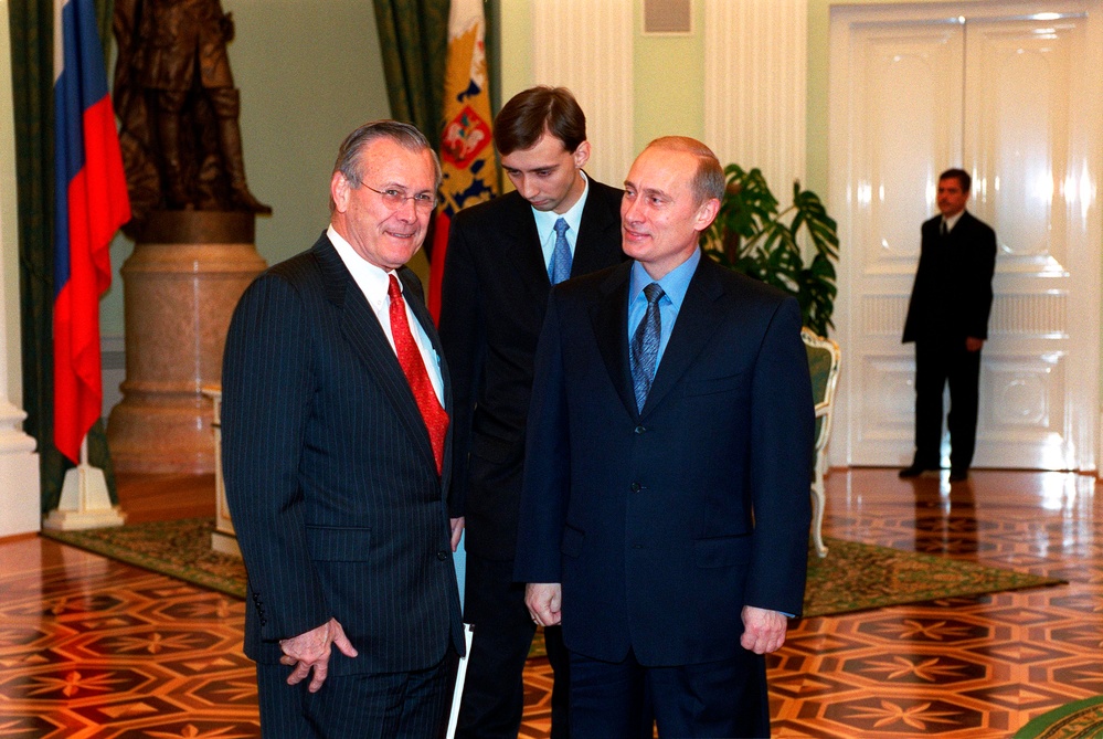Secretary Rumsfeld and Russian President Vladimir Putin pose for photographers as they meet in the Kremlin.